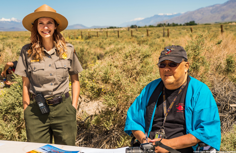 Manzanar Committee member James (Jim) To (right), shown here with former Manzanat National Historic Site staff member Katie Busch, during the 50th Annual Manzanar Pilgrimage, April 27, 2019, at the Manzanar National Historic Site. Photo by Gann Matsuda/Manzanar Committee.